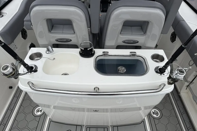 Slide: The Image of 2024 Boston Whaler 280 Outrage fishing station with rod holders and sink. - 10
