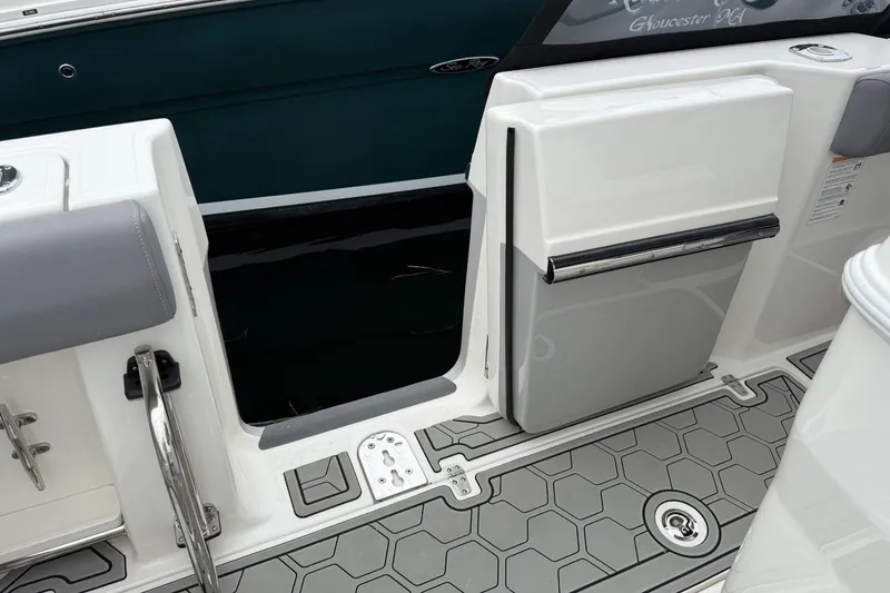 Slide: The Image of 2024 Boston Whaler 280 Outrage boat deck with open side door and gray flooring. - 11