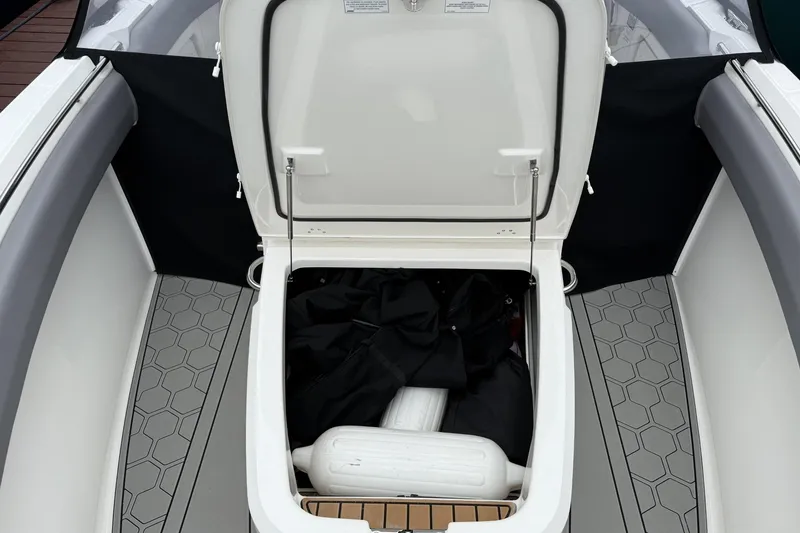 Slide: The Image of Open storage compartment on 2024 Boston Whaler 280 Outrage boat, featuring hexagonal floor design. - 17