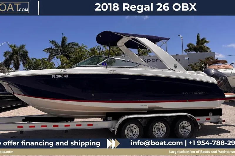 The Image of 2018 Regal 26 OBX boat on trailer, displayed outdoors with palm trees in background. - 0