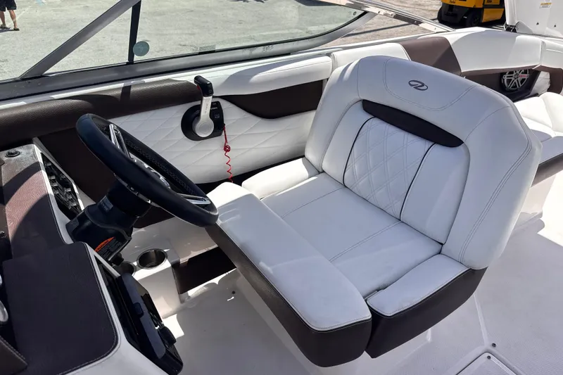 Slide: The Image of 2018 Regal 26 OBX boat interior with white leather seating and steering wheel. - 14