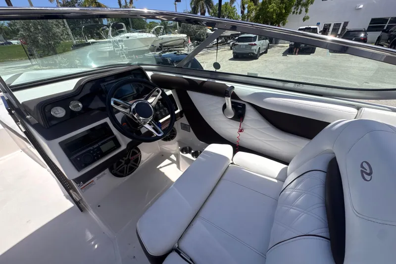 Slide: The Image of Interior view of a 2018 Regal 26 OBX boat, featuring a sleek dashboard and comfortable seating. - 15