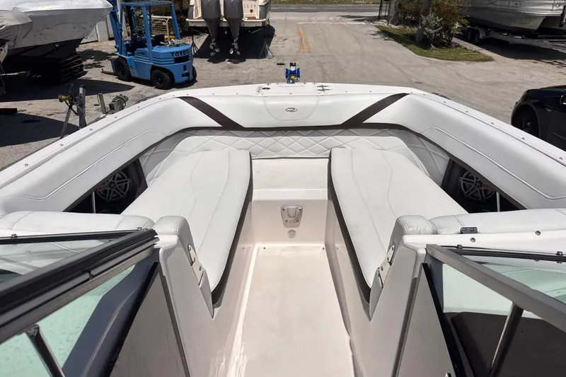 Slide: The Image of 2018 Regal 26 OBX boat interior with white seating and open bow design. - 16