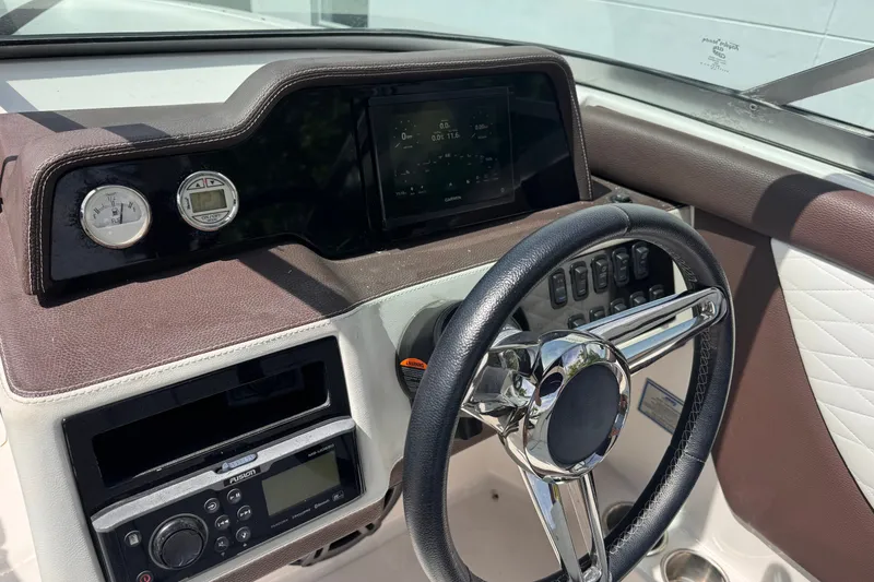 Slide: The Image of Dashboard of a 2018 Regal 26 OBX boat with steering wheel and controls. - 14