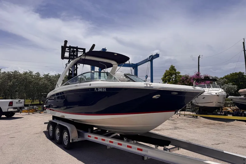 Slide: The Image of 2018 Regal 26 OBX boat on trailer, parked outdoors under a cloudy sky. - 6
