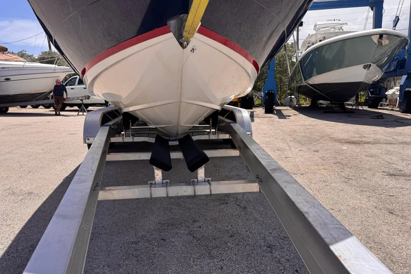 Slide: The Image of 2018 Regal 26 OBX boat on trailer in marina setting. - 7