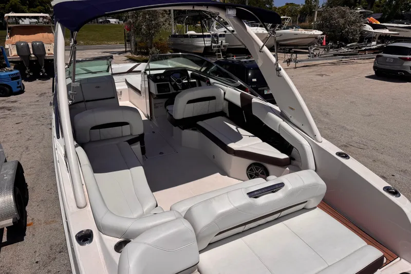 Slide: The Image of 2018 Regal 26 OBX boat interior with white seating and modern dashboard. - 9