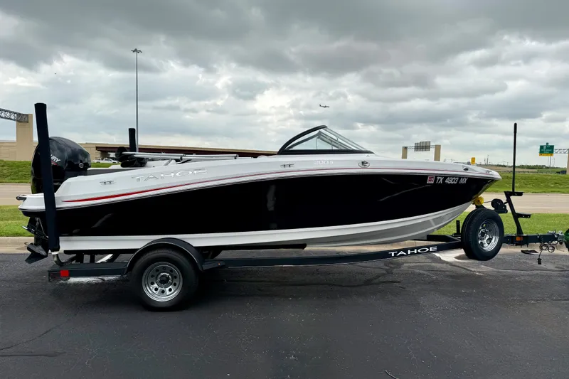 The Image of 2024 Tahoe 200 S boat on trailer, parked outdoors under cloudy sky. - 1
