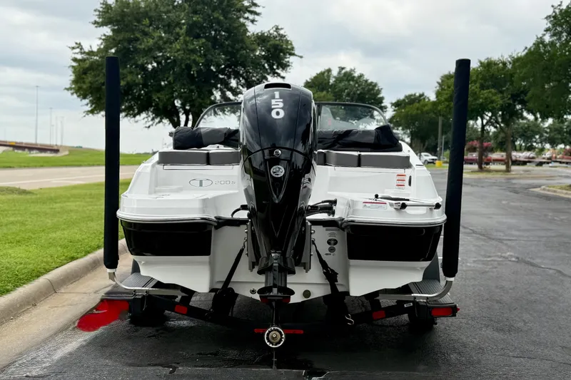 Slide: The Image of 2024 Tahoe 200 S boat with 150 HP engine, parked outdoors. - 6