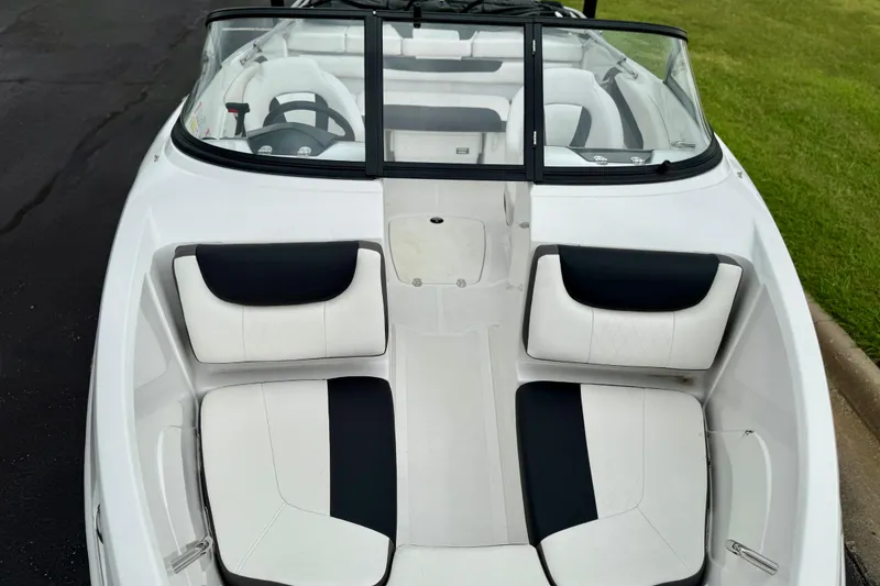 Slide: The Image of 2024 Tahoe 200 S boat interior with white and black seating, sleek design. - 5