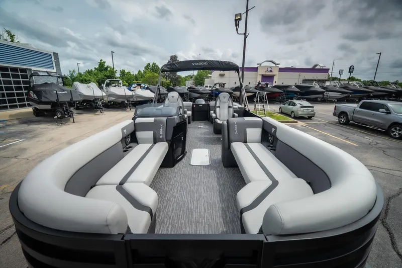 Slide: The Image of 2026 Viaggio Lago X-U 24 pontoon boat with spacious seating, parked outdoors under cloudy skies. - 13
