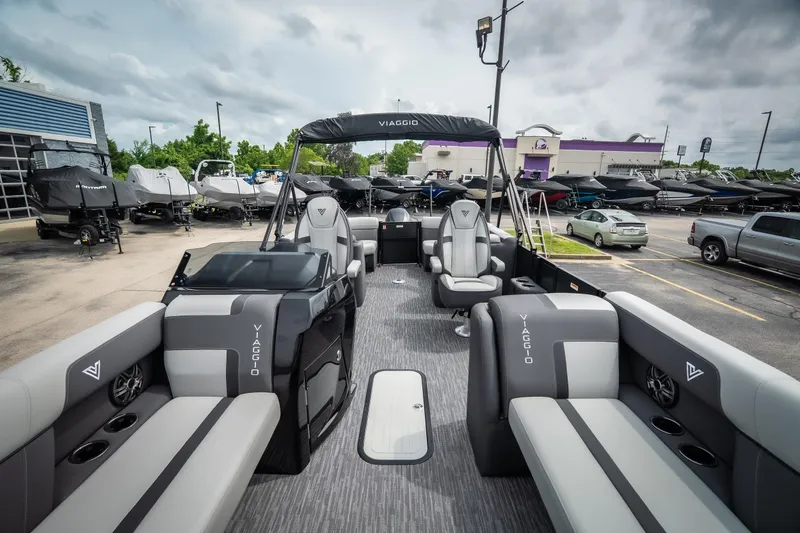 Slide: The Image of 2026 Viaggio Lago X-U 24 pontoon boat with sleek seating and modern design in a dealership lot. - 17