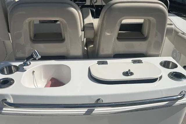 Slide: The Image of 2016 Boston Whaler 270 Dauntless boat interior with seating and utility area. - 22
