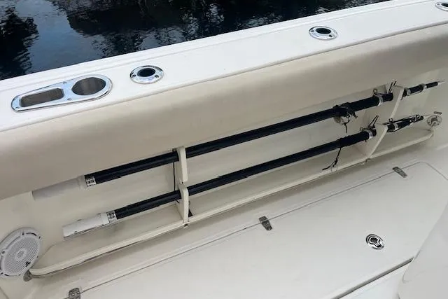 Slide: The Image of 2016 Boston Whaler 270 Dauntless boat with rod holders and storage compartment. - 9