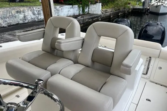 Slide: The Image of Luxury seating on a 2016 Boston Whaler 270 Dauntless boat, docked by the water. - 13