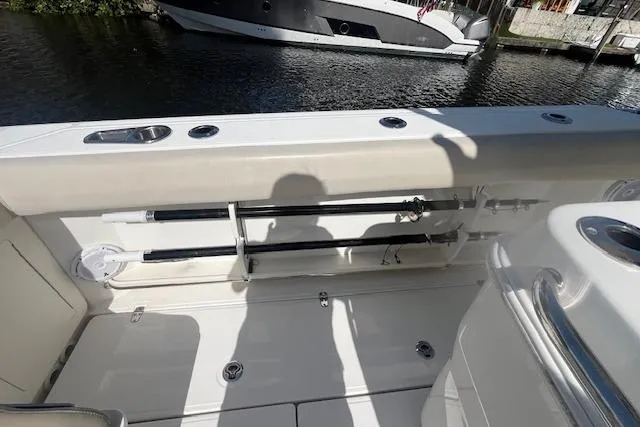 Slide: The Image of 2016 Boston Whaler 270 Dauntless boat deck with fishing rod holders and water view. - 24