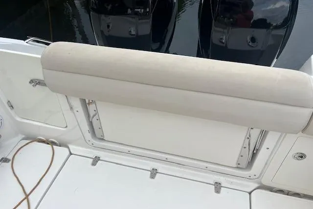 Slide: The Image of 2016 Boston Whaler 270 Dauntless boat seating area with cushioned backrest. - 10