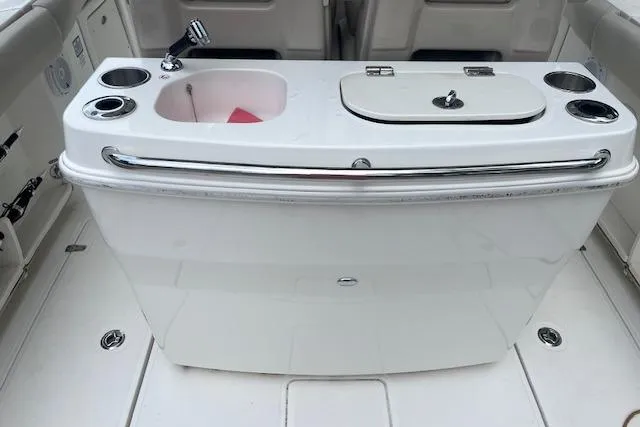 Slide: The Image of 2016 Boston Whaler 270 Dauntless boat interior with sink and storage compartments. - 8