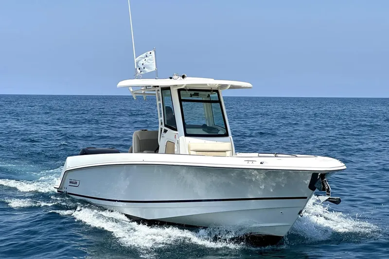 The Image of 2016 Boston Whaler 270 Dauntless cruising on open sea under clear blue sky. - 0