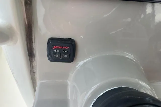 Slide: The Image of Control panel on a 2016 Boston Whaler 270 Dauntless boat, featuring Mercury switches. - 4