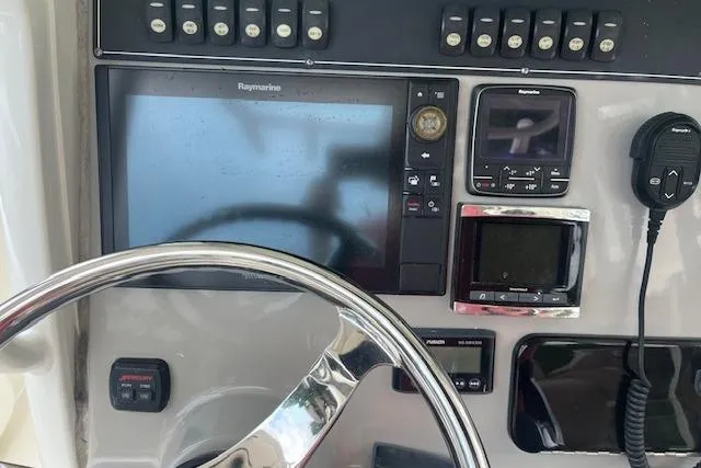 Slide: The Image of Control panel of 2016 Boston Whaler 270 Dauntless with steering wheel and navigation equipment. - 15