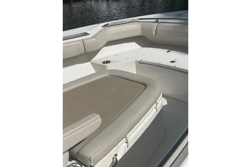 Slide: The Image of 2016 Boston Whaler 270 Dauntless boat interior with cushioned seating and storage. - 18