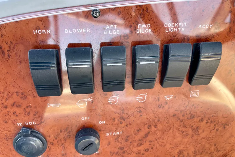Slide: The Image of Control panel of a 2008 Bayliner 265 boat with labeled switches. - 12
