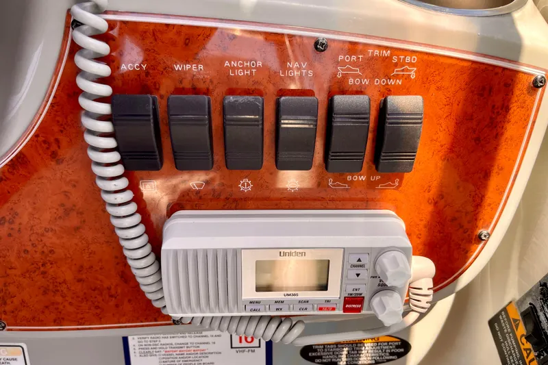Slide: The Image of Control panel of a 2008 Bayliner 265 boat with switches and a Uniden radio. - 13