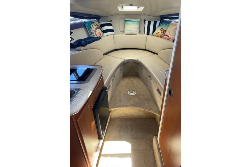 Slide: The Image of Interior of 2008 Bayliner 265 boat with cozy seating and kitchenette. - 14