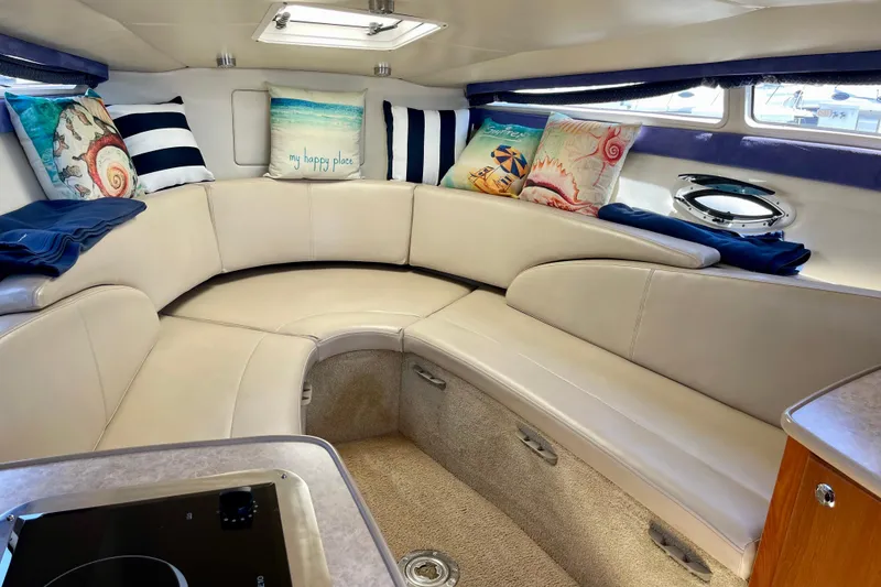 Slide: The Image of Interior of 2008 Bayliner 265 boat with cozy seating and decorative pillows. - 15
