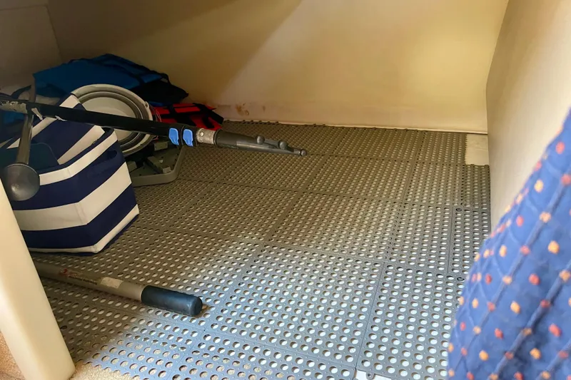 Slide: The Image of Storage area in a 2008 Bayliner 265 boat with fishing gear and life jackets. - 18