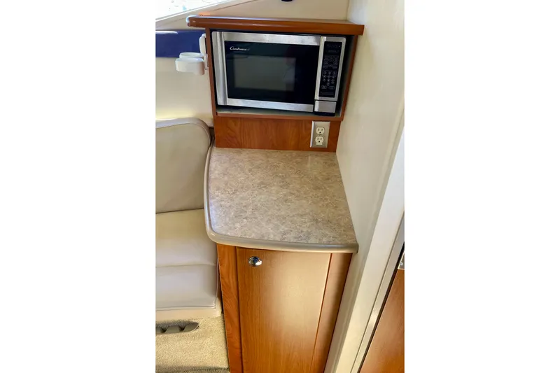 Slide: The Image of 2008 Bayliner 265 interior with microwave and countertop in cabin area. - 19
