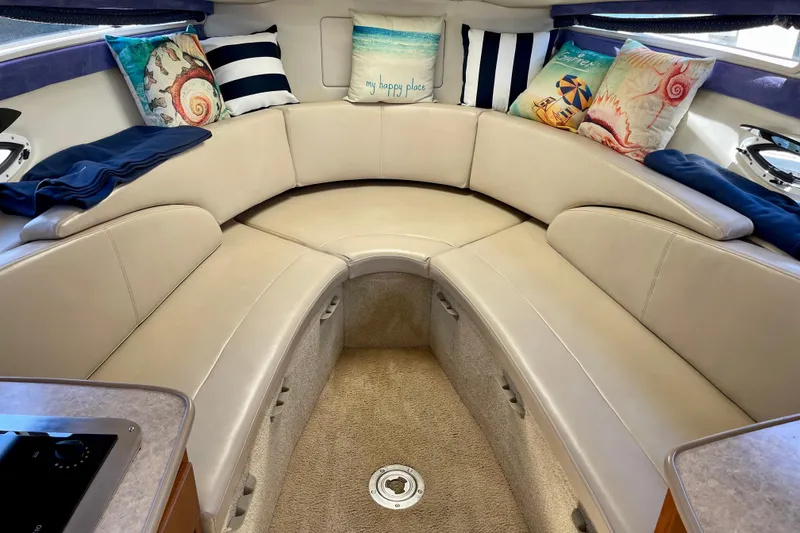 Slide: The Image of Interior of 2008 Bayliner 265 boat with cozy seating and decorative pillows. - 21