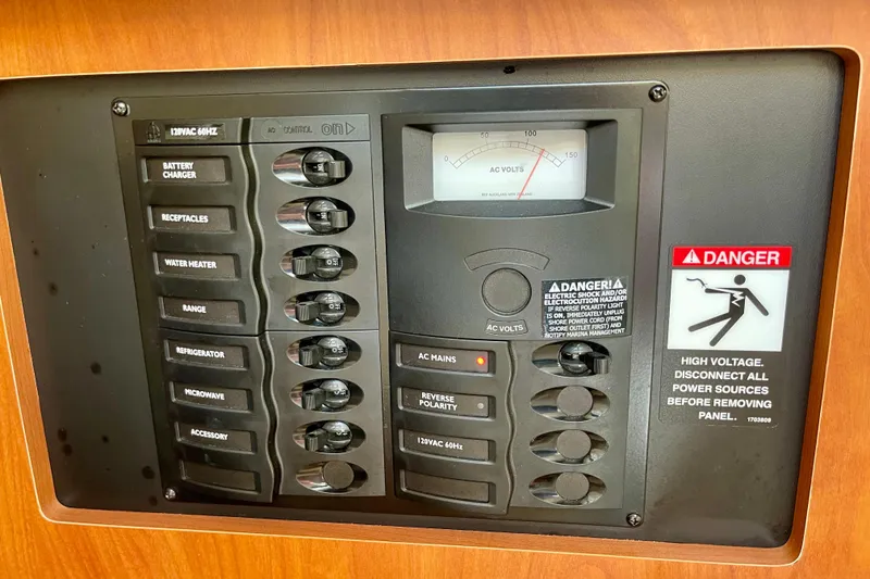 Slide: The Image of Electrical control panel on a 2008 Bayliner 265 boat with safety warnings. - 25