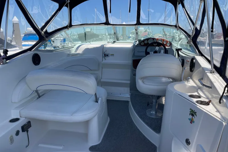 Slide: The Image of Interior of a 2008 Bayliner 265 boat with white seating and steering console. - 6