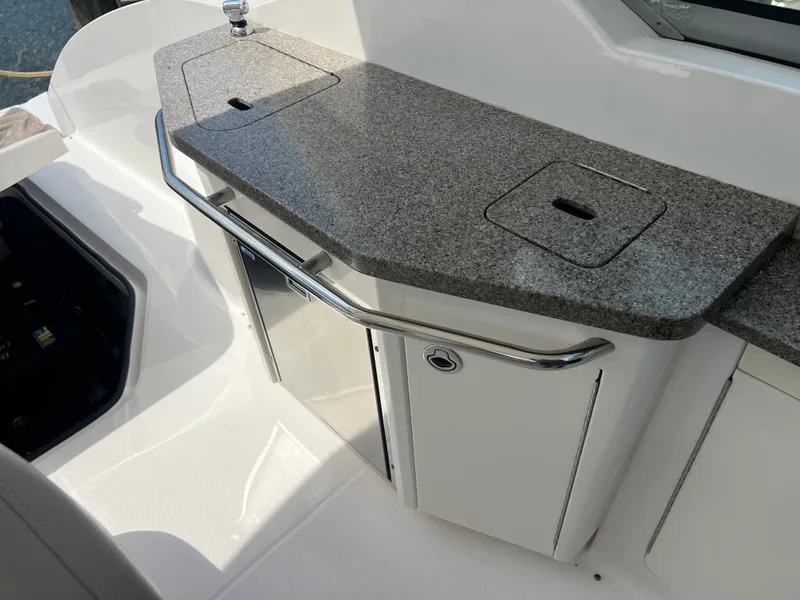 Slide: The Image of The 2013 Chaparral 330 Signature features a cockpit galley with a countertop and storage. - 14
