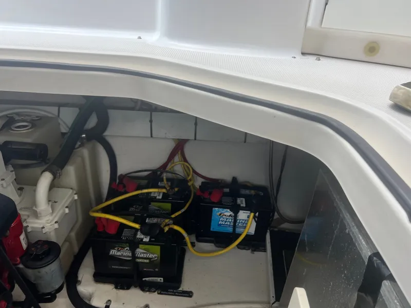 Slide: The Image of View of a 2013 Chaparral 330 Signature engine compartment with batteries and wiring. - 19