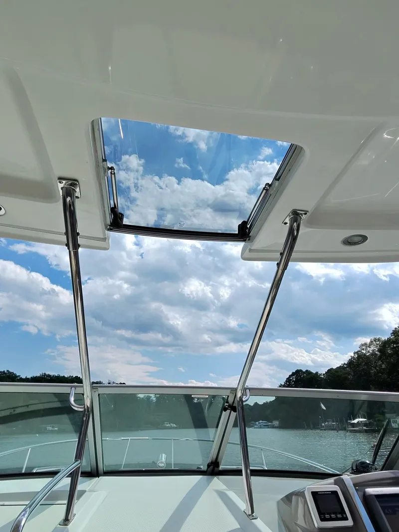 Slide: The Image of View through the open sunroof of a boat, showing blue sky with clouds. - 21