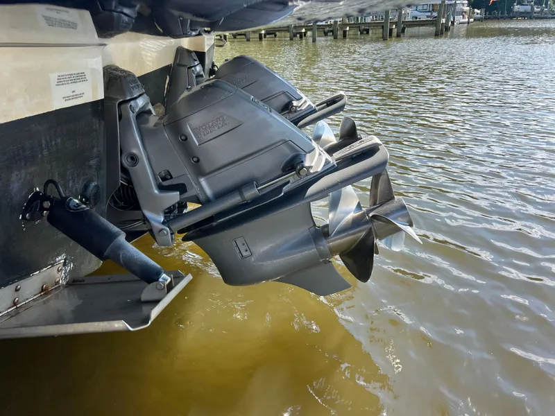 Slide: The Image of Two outboard motors of a 2013 Chaparral 330 Signature in the water, near a dock. - 31