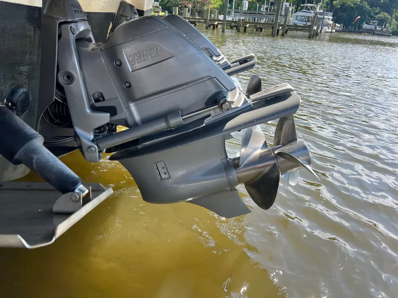 Slide: The Image of A Volvo Penta outboard motor on a boat in the water, with a clear view of the propeller. - 32
