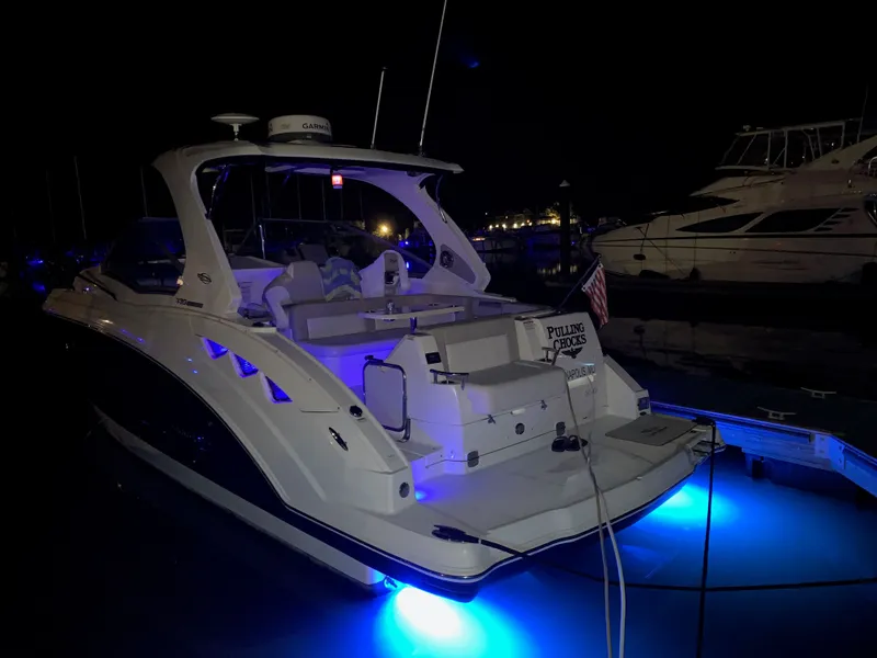 Slide: The Image of 2013 Chaparral 330 Signature at night with blue underwater lighting. - 40