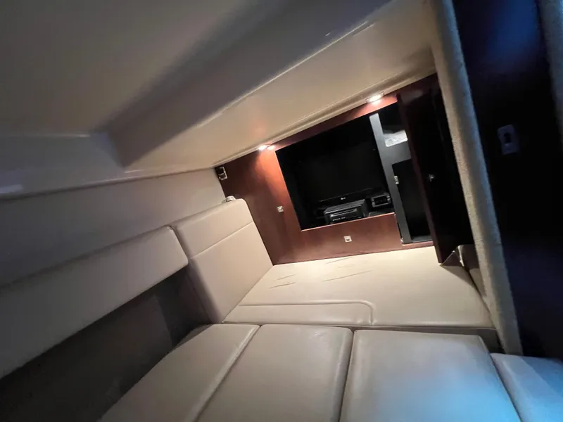 Slide: The Image of Interior of the Chaparral 330 Signature with beige upholstery and built-in TV. - 9