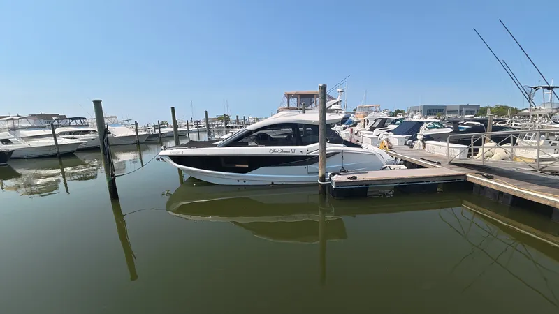 Slide: The Image of A modern Galeon 375 GTO is docked in a calm marina. - 46