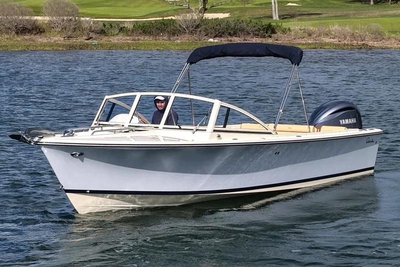 The Image of 2027 Rossiter 23 Closed Deck boat cruising on a calm lake with Yamaha engine. - 0