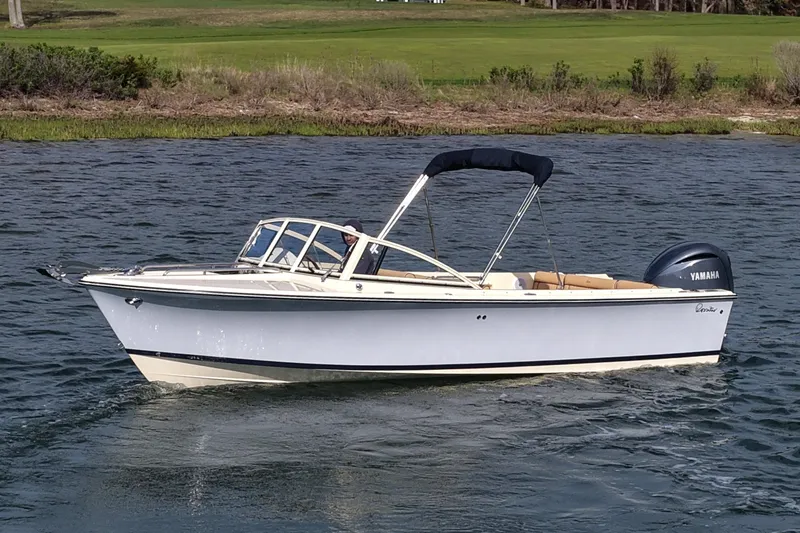 Slide: The Image of 2027 Rossiter 23 Closed Deck boat cruising on a calm lake with Yamaha engine. - 10