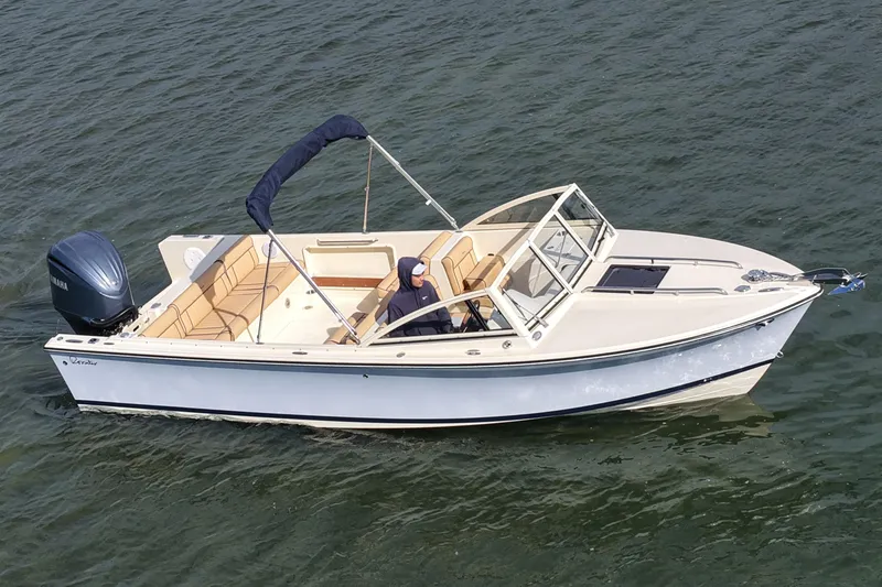 Slide: The Image of 2027 Rossiter 23 Closed Deck boat cruising on water, featuring sleek design and comfortable seating. - 12