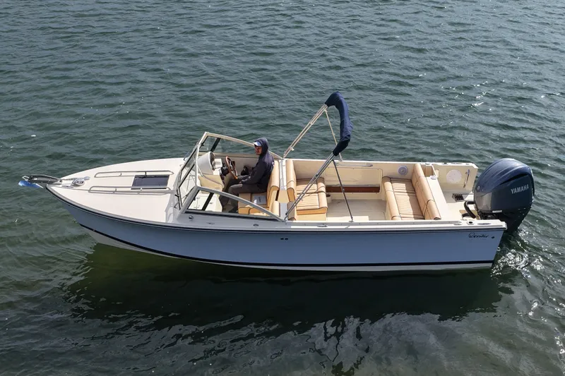 Slide: The Image of 2027 Rossiter 23 Closed Deck boat cruising on water with Yamaha engine. - 14