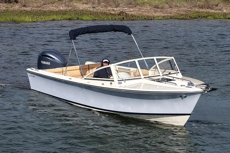 Slide: The Image of 2027 Rossiter 23 Closed Deck boat cruising on water with Yamaha engine. - 2