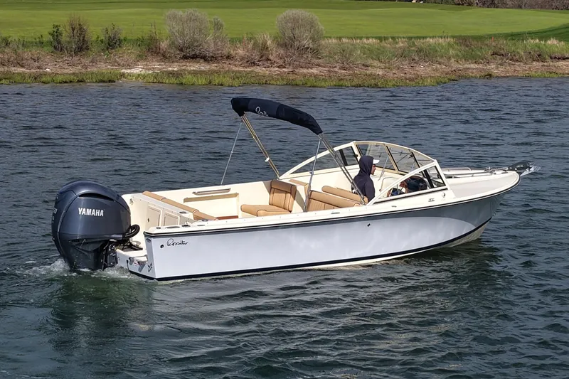 Slide: The Image of 2027 Rossiter 23 Closed Deck boat cruising on a lake with Yamaha outboard motor. - 4