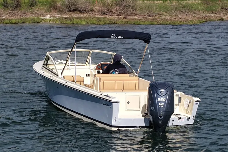 Slide: The Image of 2027 Rossiter 23 Closed Deck boat cruising on a lake with a powerful outboard motor. - 7